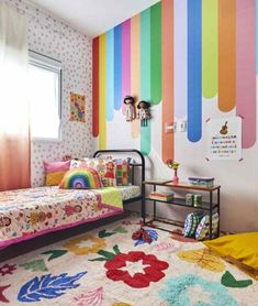 a child's bedroom with colorful wallpaper and rainbow accents on the walls, along with a twin bed