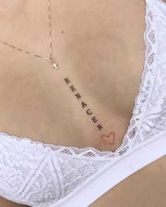 the back of a woman's stomach with her name written on it and a heart