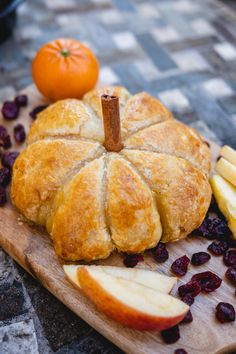 an apple and cranberry bread on a cutting board