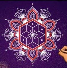 a person drawing on a purple background with an orange and red geometric design in the center