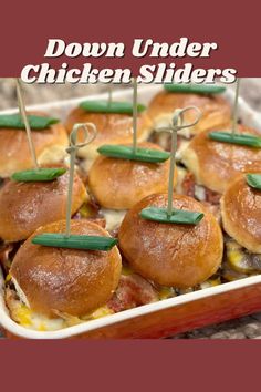 several mini sliders in a casserole dish with toothpicks sticking out of them