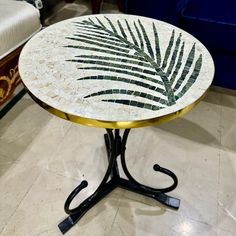 a table with a leaf design on it in a room next to a blue chair