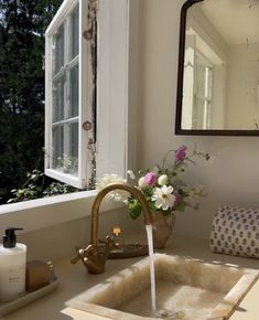 a bathroom sink with a faucet running water from it's spout