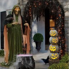 an outdoor halloween decoration with pumpkins and jack - o'- lanterns