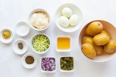 the ingredients are laid out in bowls on the table to be used as an appetizer