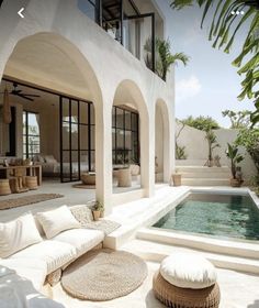 an outdoor living area with a pool and patio furniture