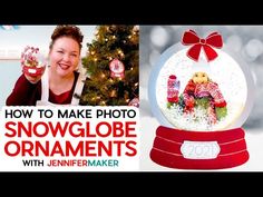 a snow globe ornament with a woman holding it in front of a christmas tree