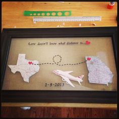 a couple of framed pictures sitting on top of a wooden table next to a ruler