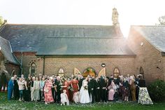 a large group of people standing in front of a church