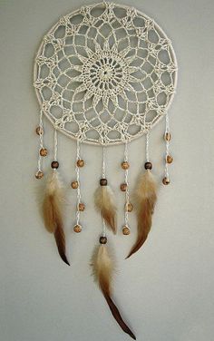 a white dream catcher hanging on the wall