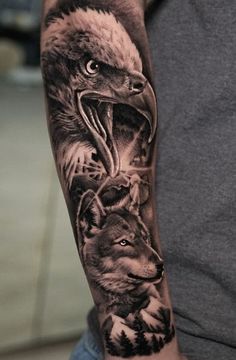 an eagle and wolf tattoo on the arm