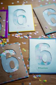 four cards with the number six on them and confetti scattered around each card