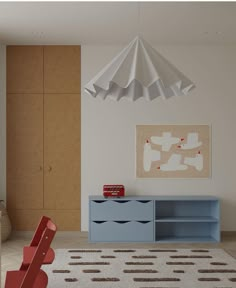 a room with a blue dresser and red chair