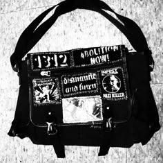 a black and white photo of a handbag with stamps all over it's sides