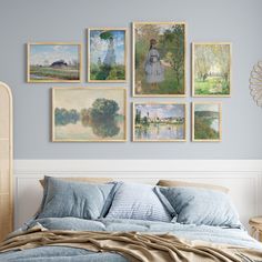 a bedroom with blue walls and paintings on the wall