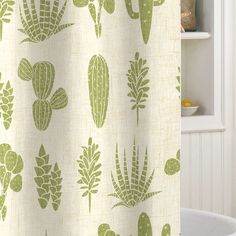 a shower curtain with green cactus designs on it