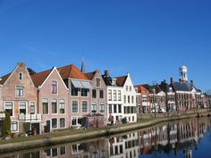 some buildings are reflected in the water