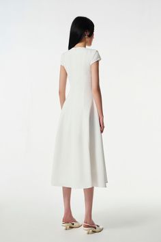 This dress is made from a blend of wool and cotton, giving it the perfect combination of durability and comfort. The classic short-sleeved silhouette is ideal for everyday or special occasions, making it a timeless wardrobe staple. White Short Sleeve Midi Dress For Formal Occasions, White Short Sleeve Formal Midi Dress, Classic Short Sleeve Midi Dress, White Short Sleeve Midi Dress For Work, Elegant Short Sleeve Midi Dress For Daywear, Timeless White Dress For Work, Classic Short Sleeve Midi Dress For Spring, Elegant Fitted Short Sleeve Dress For Daywear, Classic Short Sleeve Midi Dress For Work