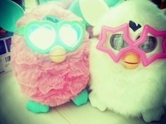 two stuffed animals with sunglasses on their faces and one has a heart shaped eye patch