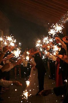 a group of people holding sparklers in their hands