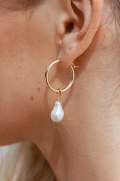 An unfailing new classic. Our Baroque White Pearl Hoops are steadfast companions. Seemingly plucked straight from the ocean, the luminous, organic white pearls sway below bold gold filled hoops. This gorgeous pair is perfect solo or teamed with a pair of staple huggie hoops for a modern upgrade. ✦ Sea Jay is wearing size Large; Tatiana is wearing size Small ✦ ✦ DETAILS ✦ ✧ Name: Kēhau (keh-how) - dewdrop. ✧ 14kt Gold Filled Hoops. ✧ Available in two sizes. Sold as a pair. ✧ Genuine Freshwater Ba Hoop Pearl Earrings, Earrings Gold Pearl, Pearl Earrings Gold, Hawaii Jewelry, Earrings Gold Hoop, Gold Filled Hoops, Hoop Earrings Gold, Earring Gold, Gold Pearl Earrings