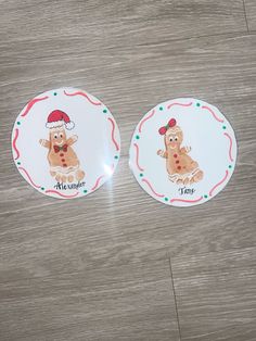 two plates with cartoon characters on them sitting on a wooden floor next to each other