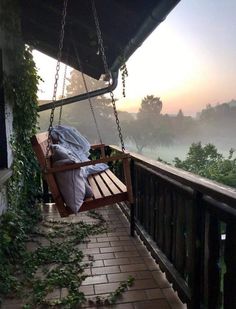 a wooden swing hanging from the side of a building