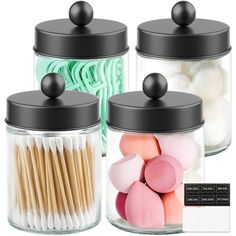 three jars filled with different types of marshmallows and cotton swabs