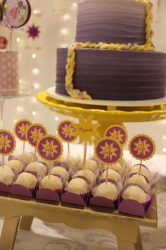 a table topped with lots of cake and cupcakes