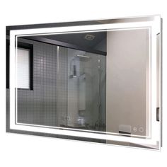 a bathroom mirror that has a light on in front of it and is reflecting the shower