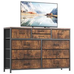 an entertainment center with drawers and a flat screen tv