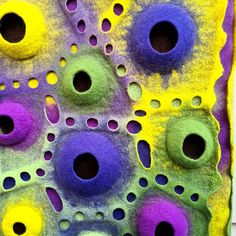 an art project made out of felt with holes in the middle