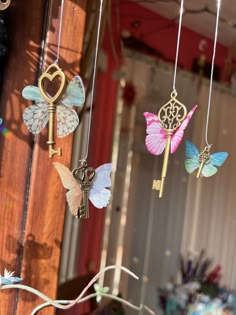 some keys are hanging from strings with butterflies on them