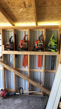 some tools are sitting on shelves in a storage area that is made out of pallets