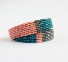 two different colored bracelets sitting on top of each other