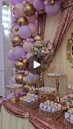 a table topped with lots of cakes and cupcakes