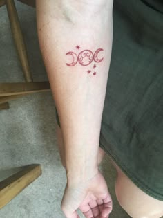 a person with a tattoo on their arm holding the hand of another person's leg