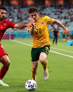 two men are playing soccer on the field