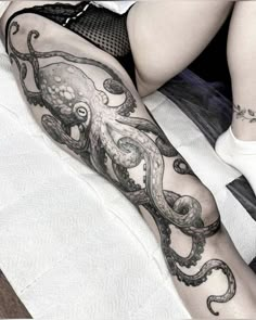 an octopus tattoo on the leg of a woman