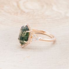 Ring Style: The "Octavia" is a hexagon moss agate women's engagement ring with a diamond halo and accents Center Stone: 11x7mm Elongated Hexagon Cut Moss Agate Accent Stones: 1/4ctw (32) 0.9mm Round Diamonds (6) Round Diamonds Available In: 14K White Gold, 14K Yellow Gold, or 14K Rose Gold Customizable: Because each ring is handcrafted to order we can customize center or accent stones, use unique materials, customize design features, or even use your own personal materials that you send us! To d Fairytale Engagement Rings, Ring Upgrade, Moss Agate Engagement Ring, Future Engagement Rings, Agate Engagement Ring, Moss Agate Ring, Ring With Diamond, Detailed Ring, Green Gems