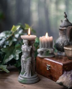 two candles sitting on top of a wooden table