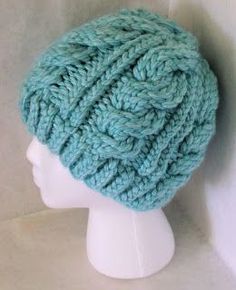 a white mannequin head wearing a blue knitted hat