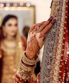 the bride is getting ready for her wedding ceremony with henna and bracelets on