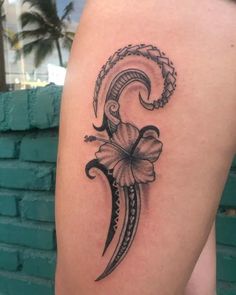 a woman's thigh with a tattoo design on it and a flower in the middle