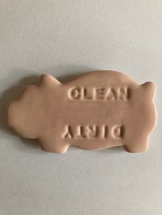 a ceramic pig with the words olean disa written on it's side