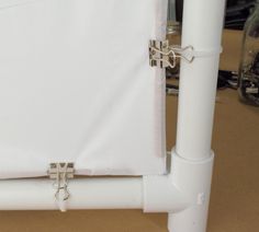 a close up of a white sheet on a bed frame with metal straps attached to it