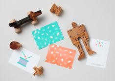 wooden toys and cards on a white surface