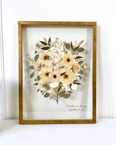 a wooden frame with flowers in it sitting on a white shelf next to a teddy bear