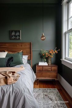 a bedroom with green walls and wooden furniture