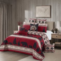 a bed room with a neatly made bed and a dog paw print on the comforter